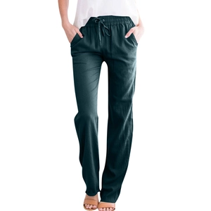Close-up of drawstring elastic waistband and side pockets on dark green linen pants