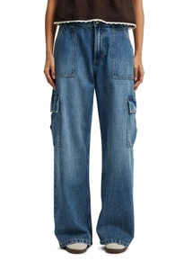 Detail of blue denim cargo pants with large side pockets and high quality washed texture