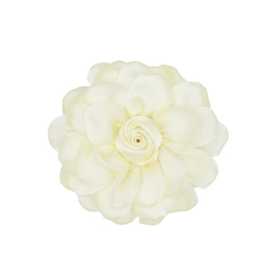 Detailed top view of cream satin fabric camellia flower accessory with silk texture
