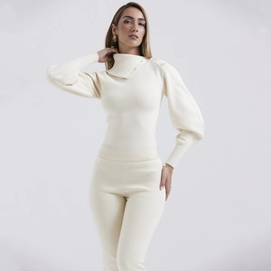 Detail of cream knit sweater with high neck buttons and elegant puff sleeves