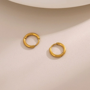 Close-up of minimalist 18K gold stainless steel hoop earrings with secure clasp mechanism