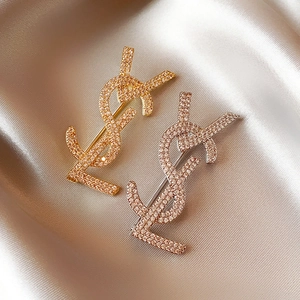 Classic 14k gold and silver plated letter brooches with pavé zircon on champagne silk