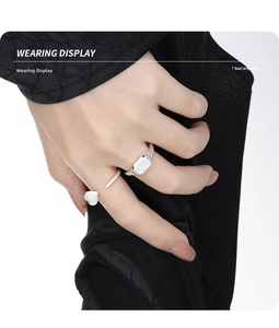 Close-up of stacked S925 sterling silver heart and geometric rectangle open rings