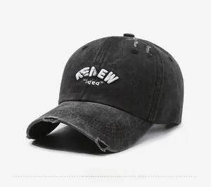 Detailed close-up of distressed black washed cotton baseball cap with RENEW embroidery