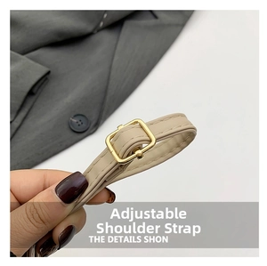 Detail of adjustable beige faux leather shoulder strap with gold-tone rectangular buckle