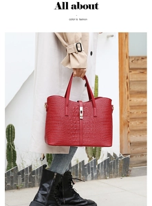 Close-up of vibrant red crocodile pattern tote bag with rectangular metal clasp detail