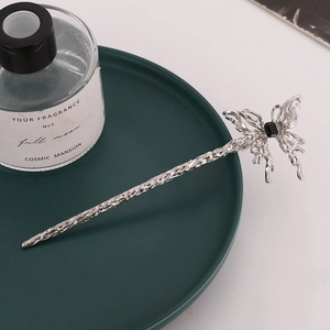 Minimalist silver metal hair pin with hollow butterfly design and black gemstone inlay