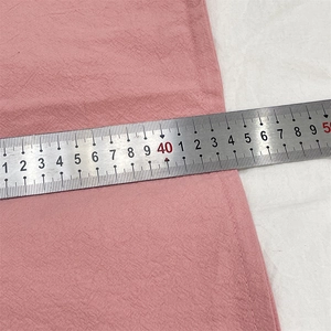 Detail shot showing 45cm width measurement of pink textured fabric cushion cover