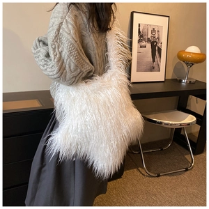 Chic white faux fur plush tote bag shown on model in a stylish indoor setting