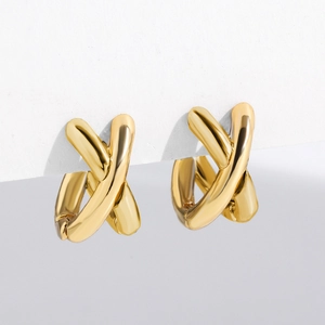 Detailed view of polished golden cross X-shaped hoop earrings with a sleek metallic finish