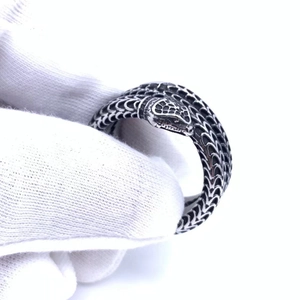 Silver and black stainless steel snake ring with textured scales and vintage finish