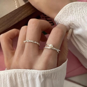 S925 Sterling Silver knotted braid and pearl open ring set on a model's hand