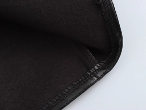 Macro shot of black PU leather edging and soft velvet lining with precise stitching detail