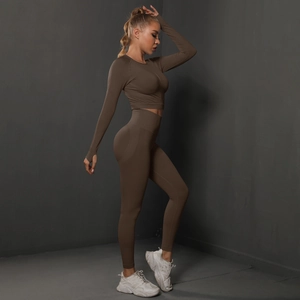 Detail view of brown long sleeve crop top with thumbholes and high waist yoga leggings set
