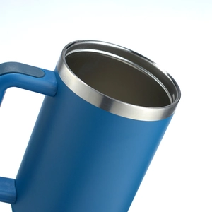 Close-up of blue insulated tumbler showing stainless steel rim and matte finish texture