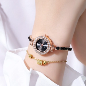 Close-up of gold gemstone watch and beaded bracelet set worn on a female wrist