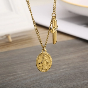 Gold plated stainless steel necklace featuring oval religious pendant and cross charm
