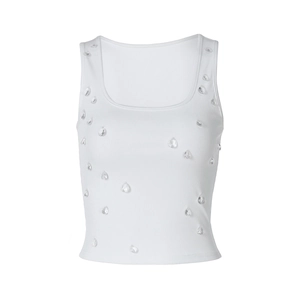 Detailed view of white ribbed tank top featuring delicate raindrop bead embellishments
