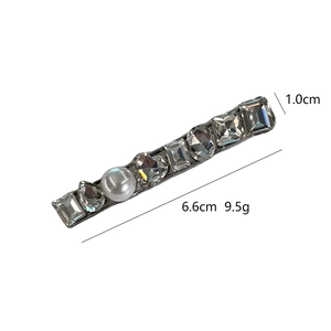 Elegant crystal and pearl hair clip featuring diverse rhinestone shapes on metal base
