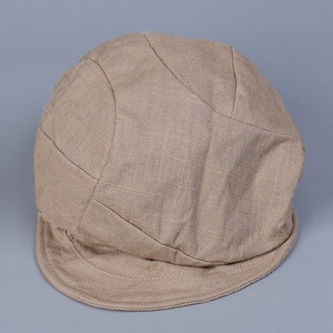 Detailed close-up showing breathable linen fabric texture of a beige peaked cap