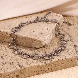 Detail of 14K gold plated stainless steel chain link anklet on textured stones