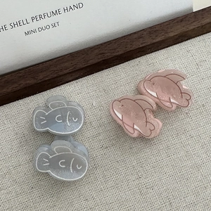 Cute dolphin fish hair claw clips in pink and grey resin with glitter for women's updos