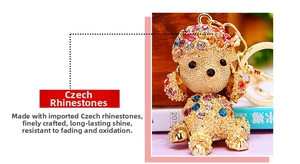 Detailed macro view of a colorful rhinestone puppy keychain with golden alloy finish