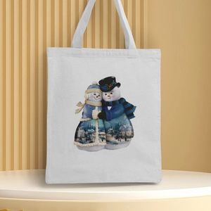 White canvas Christmas tote bag featuring a snowman couple print on a display stand