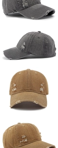 Detail view of distressed washed denim baseball caps with vintage frayed edges and holes
