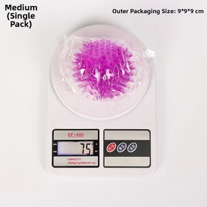 Medium purple TPR dog ball on a digital scale showing weight of 75 grams