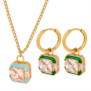 Elegant gold titanium jewelry set with pink stones and blue-green enamel squares