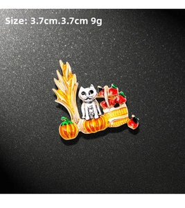 Detail of Halloween enamel brooch showing a white cat with pumpkins, 3.7cm x 3.7cm