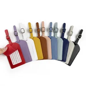 Macro view of multi-color leather passport luggage tags with adjustable metal buckles