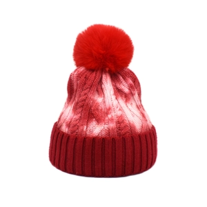 Winter tie-dye knit beanie with cable texture and red faux fur pompom for women