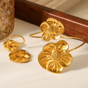 Macro detail of asymmetric 18K gold-plated stainless steel flower cuff bracelet