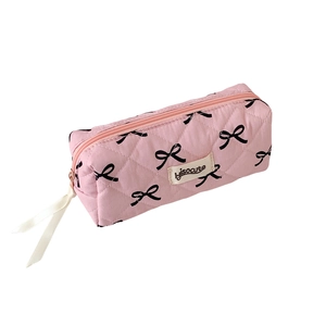 Pink quilted bow pencil case and makeup bag with zip closure and white ribbon detail