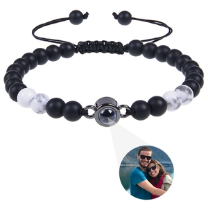 Macro detail of natural tiger eye stone bracelet with personalized photo projection lens