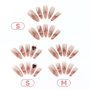 Long stiletto press-on nails with marble pattern and 3D red heart gemstones in sizes S and M