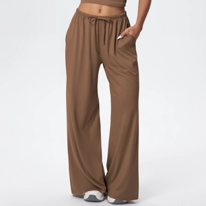 Detailed view of elastic drawstring waist and soft brown fabric on wide-leg sports pants