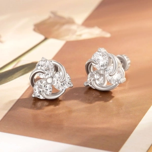 Chic silver star and moon zircon ear studs with screw backs on textured paper background