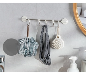 Detail of wall-mounted stainless steel rack with 5 sliding hooks in a modern bathroom