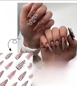 Macro detail of stiletto press on nails featuring silver snake rhinestone and french tips