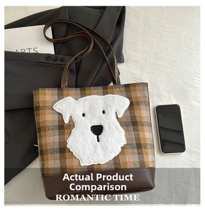 Macro detail of the plaid wool fabric and cute white plush dog patch on the tote bag