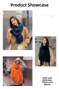 Detailed view of the thick fringe trim on winter cashmere scarves in navy, black and orange