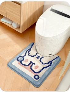 Detailed view of a plush U-shaped bathroom mat with abstract blue and white pattern