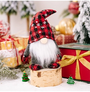 Detailed view of Christmas gnome with red and black plaid snowflake hat and white beard