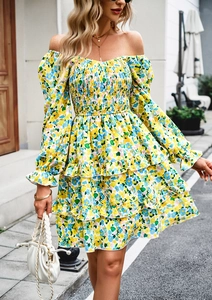 Detail of yellow floral dress featuring off-shoulder neckline and layered ruffle hem