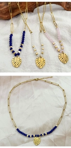 Close-up of bohemian beaded necklaces featuring 18k gold monstera leaf pendants and charms
