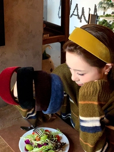 Close-up of velvet wide headbands in yellow, red, and black with high-top design
