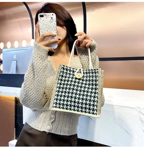 Mirror selfie showing green houndstooth canvas tote bag with woven texture and button